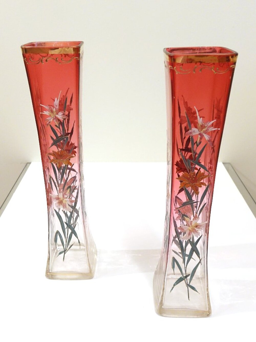 Art Nouveau-style cranberry enameled glass vases